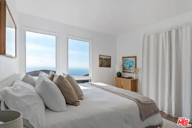 a bedroom with a bed and a table