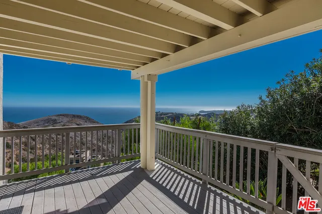 a view of balcony with wooden floor