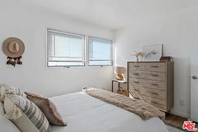 a bedroom with a bed and chair