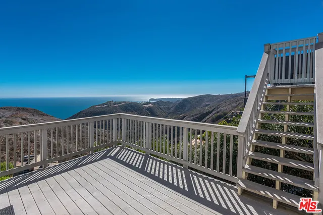 a view of balcony with wooden floor
