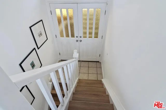 a view of a hallway with wooden floor and staircase