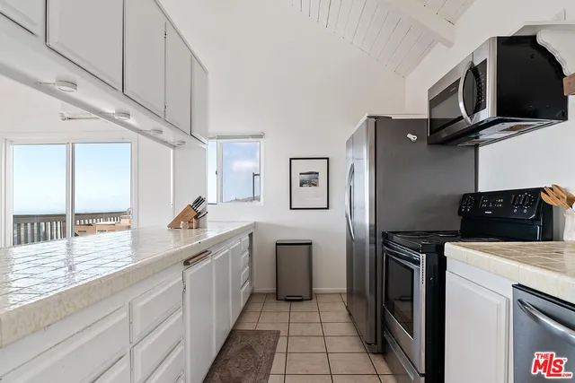 a kitchen with stainless steel appliances a stove sink and refrigerator