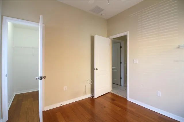 a view of a room with wooden floor