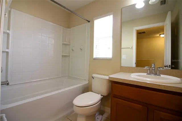 a bathroom with a sink toilet vanity and shower