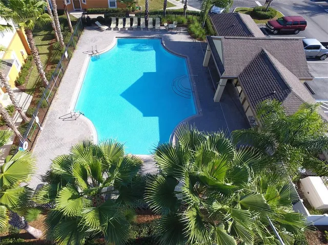 a view of a glass door with yard in front of the house