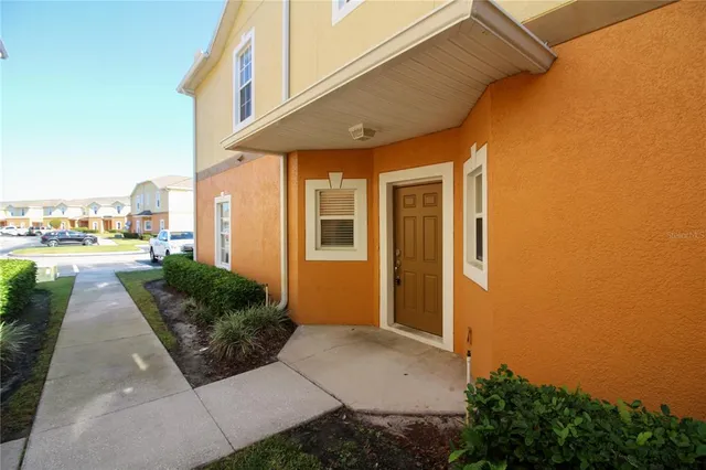 a view of a patio with table and chairs