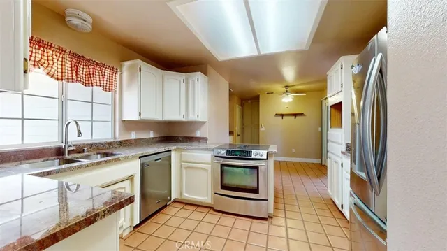 a kitchen with stainless steel appliances granite countertop a sink stove and cabinets