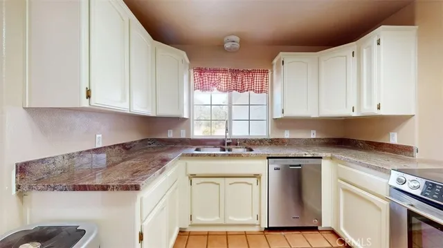 a bathroom with a granite countertop sink a mirror and vanity