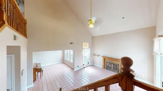 a view of a livingroom with wooden floor and a large window