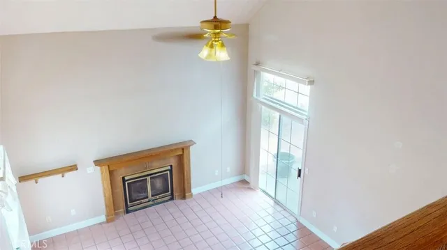 a view of a room with wooden floor and a window