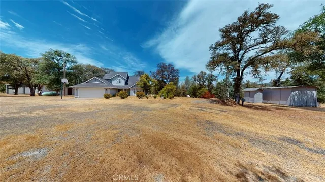 a view of a house with a yard covered with snow in front of house