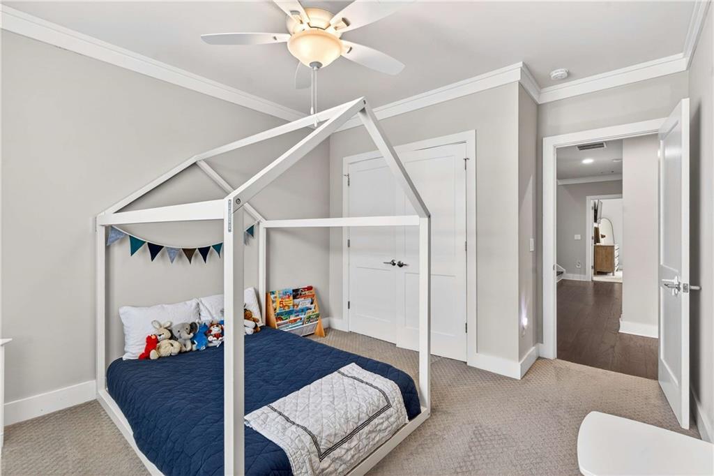 2974 Hermance Drive Northeast Atlanta, GA 30319 - Photo 27 of 38 a bed room with a bed and a chandelier