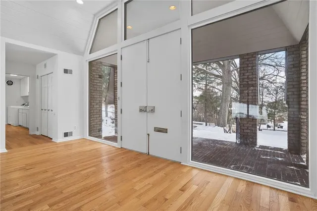 a bedroom with a bed and a large window