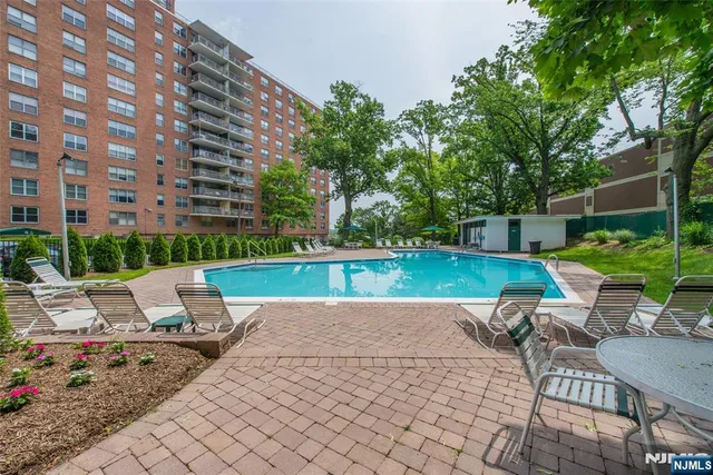 a view of backyard with swimming pool and patio