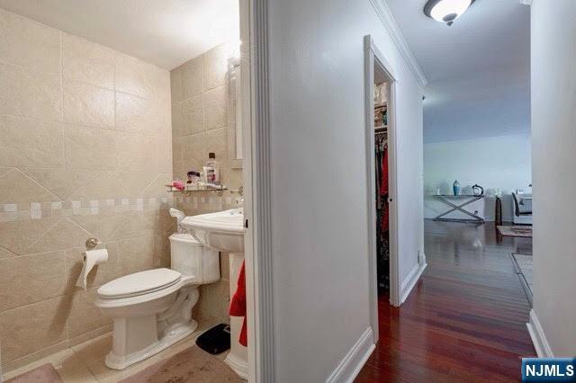 301 Beech Street, Unit 3K Hackensack, NJ 07601 - Photo 16 of 29 a bathroom with a toilet and a view of bathroom