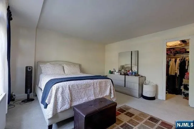 a bedroom with furniture and a lamp