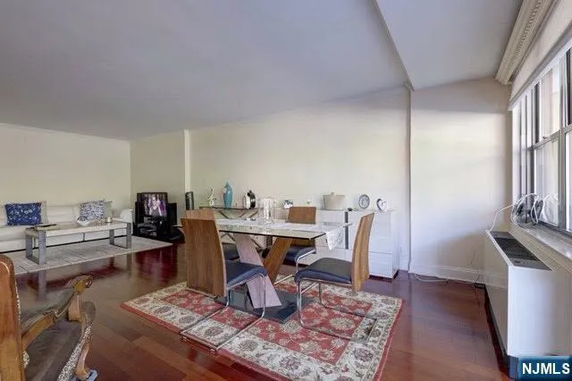 a living room with furniture a rug and a table