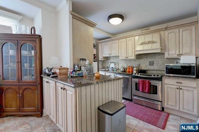 301 Beech Street, Unit 3K Hackensack, NJ 07601 - Photo 22 of 29 a kitchen with stainless steel appliances granite countertop a stove a sink and a refrigerator