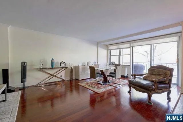 a living room with furniture and a floor to ceiling window
