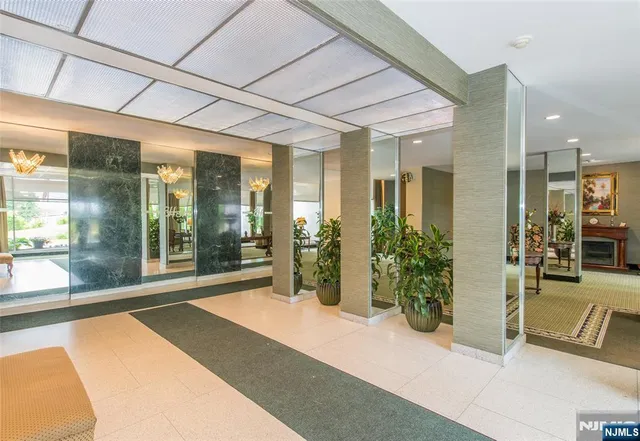 a lobby with furniture and floor to ceiling window