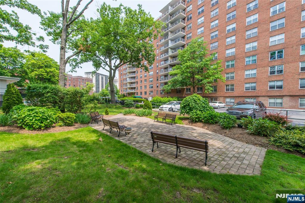 301 Beech Street, Unit 3K Hackensack, NJ 07601 - Photo 10 of 29 a garden with trees in front of it