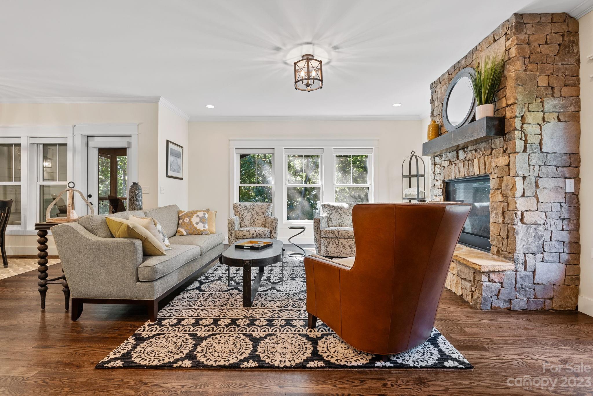 37 Still Creek Loop Fairview, NC 28730 - Photo 12 of 46 a living room with furniture a rug and a chandelier