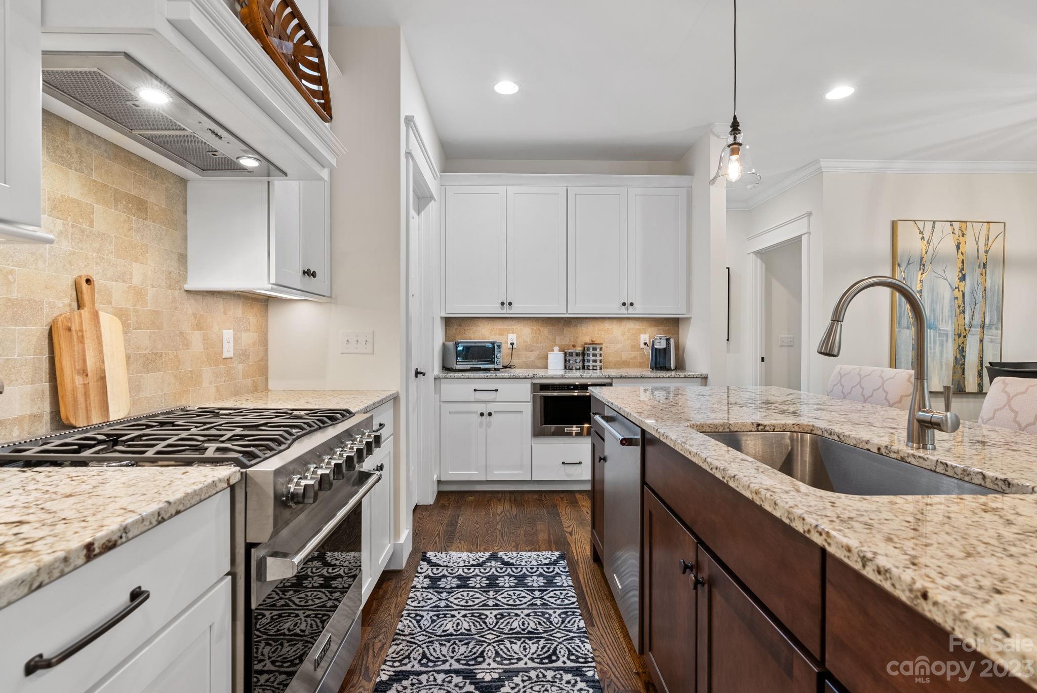 37 Still Creek Loop Fairview, NC 28730 - Photo 16 of 46 a kitchen with granite countertop a sink stove and cabinets
