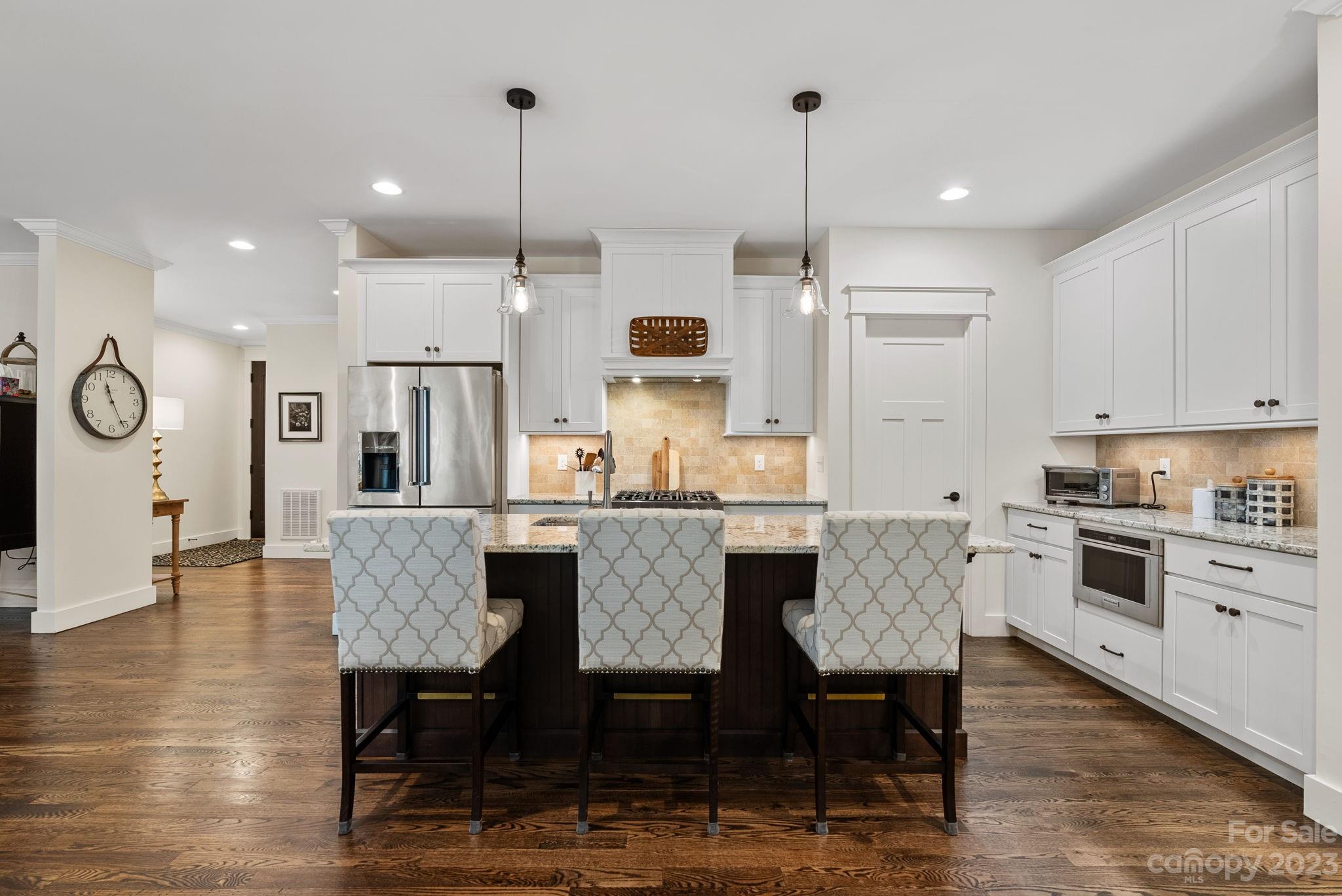 37 Still Creek Loop Fairview, NC 28730 - Photo 5 of 46 a kitchen with granite countertop a table chairs a sink dishwasher refrigerator and microwave