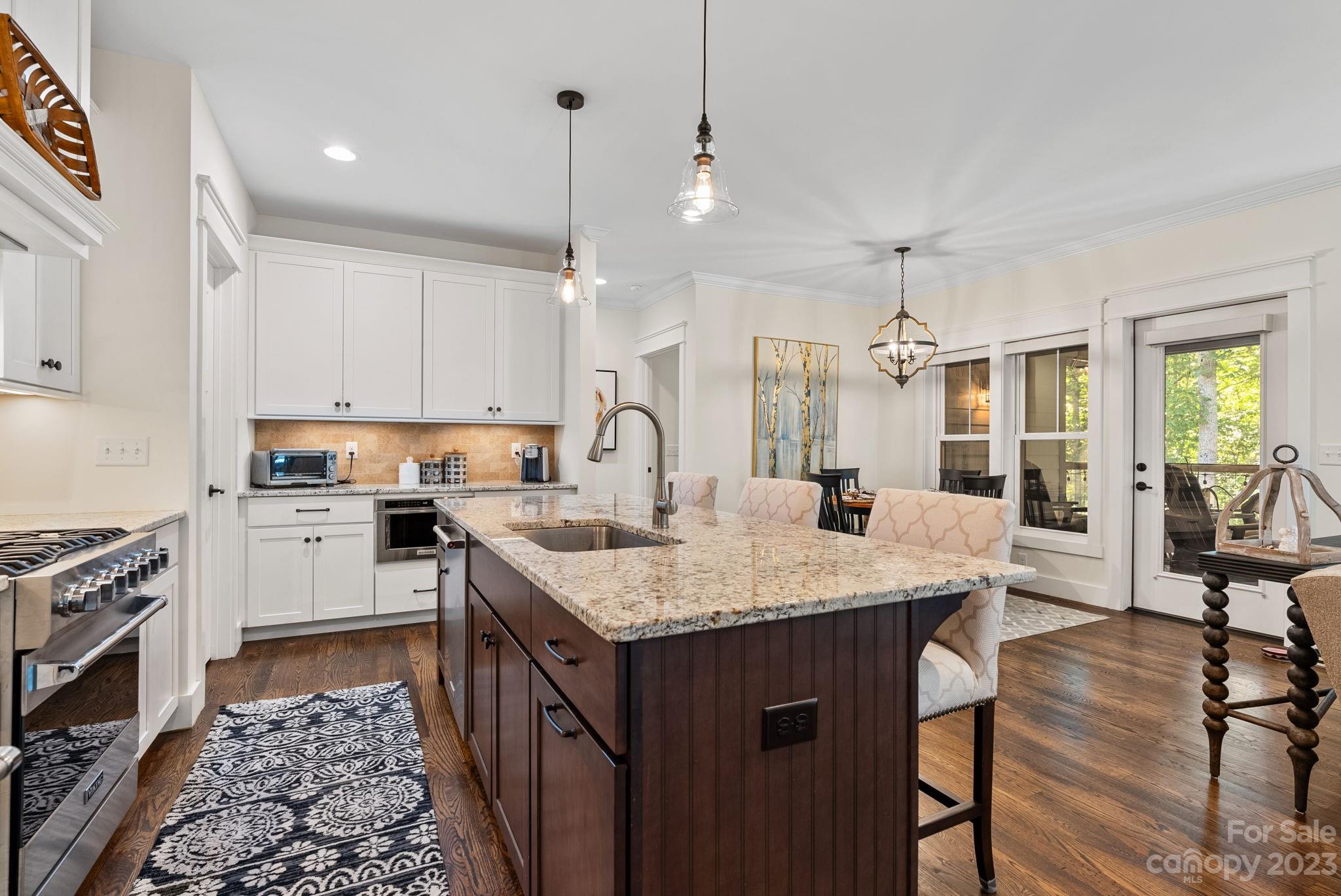 37 Still Creek Loop Fairview, NC 28730 - Photo 6 of 46 a kitchen with a stove a sink a dining table and chairs
