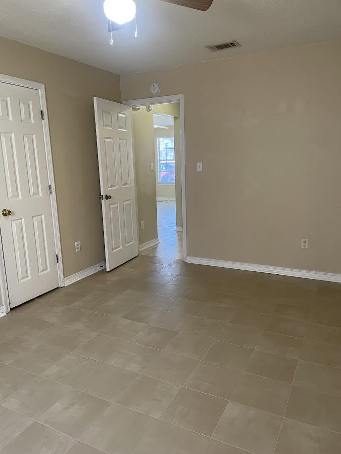 6905 Sea Turtle Circle, Unit E Navarre, FL 32566 - Photo 12 of 14 an empty room with wooden floor and windows