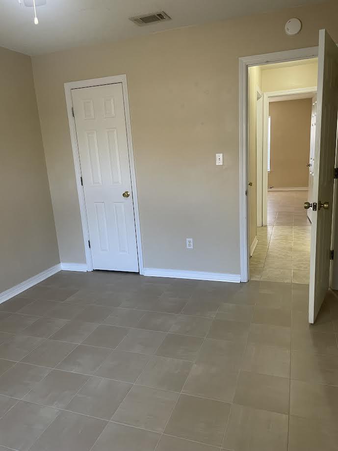 6905 Sea Turtle Circle, Unit E Navarre, FL 32566 - Photo 14 of 14 an empty room with closet and mirror