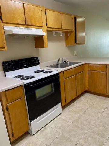 a kitchen with a stove and a sink