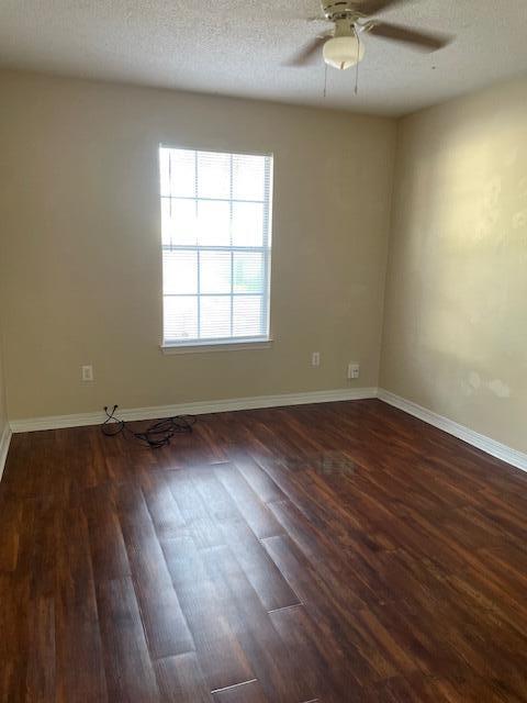 6905 Sea Turtle Circle, Unit E Navarre, FL 32566 - Photo 7 of 13 an empty room with wooden floor and windows