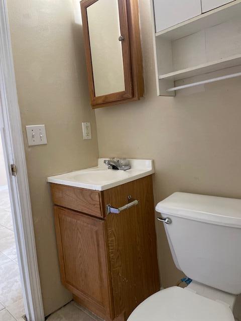 6905 Sea Turtle Circle, Unit E Navarre, FL 32566 - Photo 10 of 14 a bathroom with a sink toilet and mirror