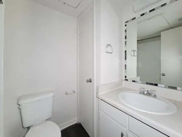 a bathroom with a toilet sink and mirror