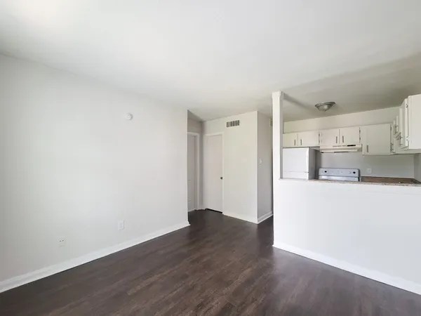 a view of a kitchen with wooden floor