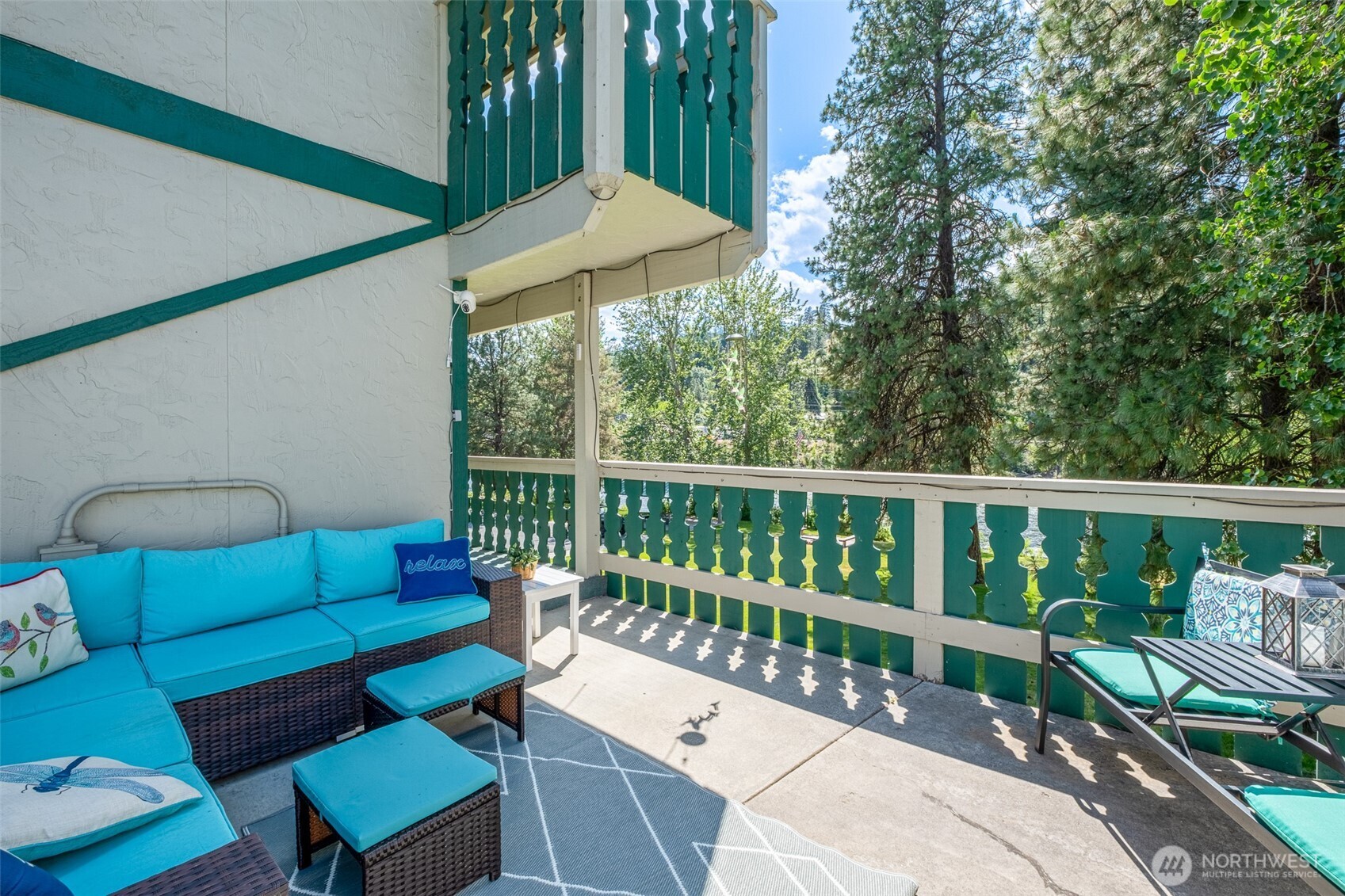 8348 Main Street, Unit 1 Peshastin, WA 98847 - Photo 22 of 40 a roof deck with a table and chairs under an umbrella