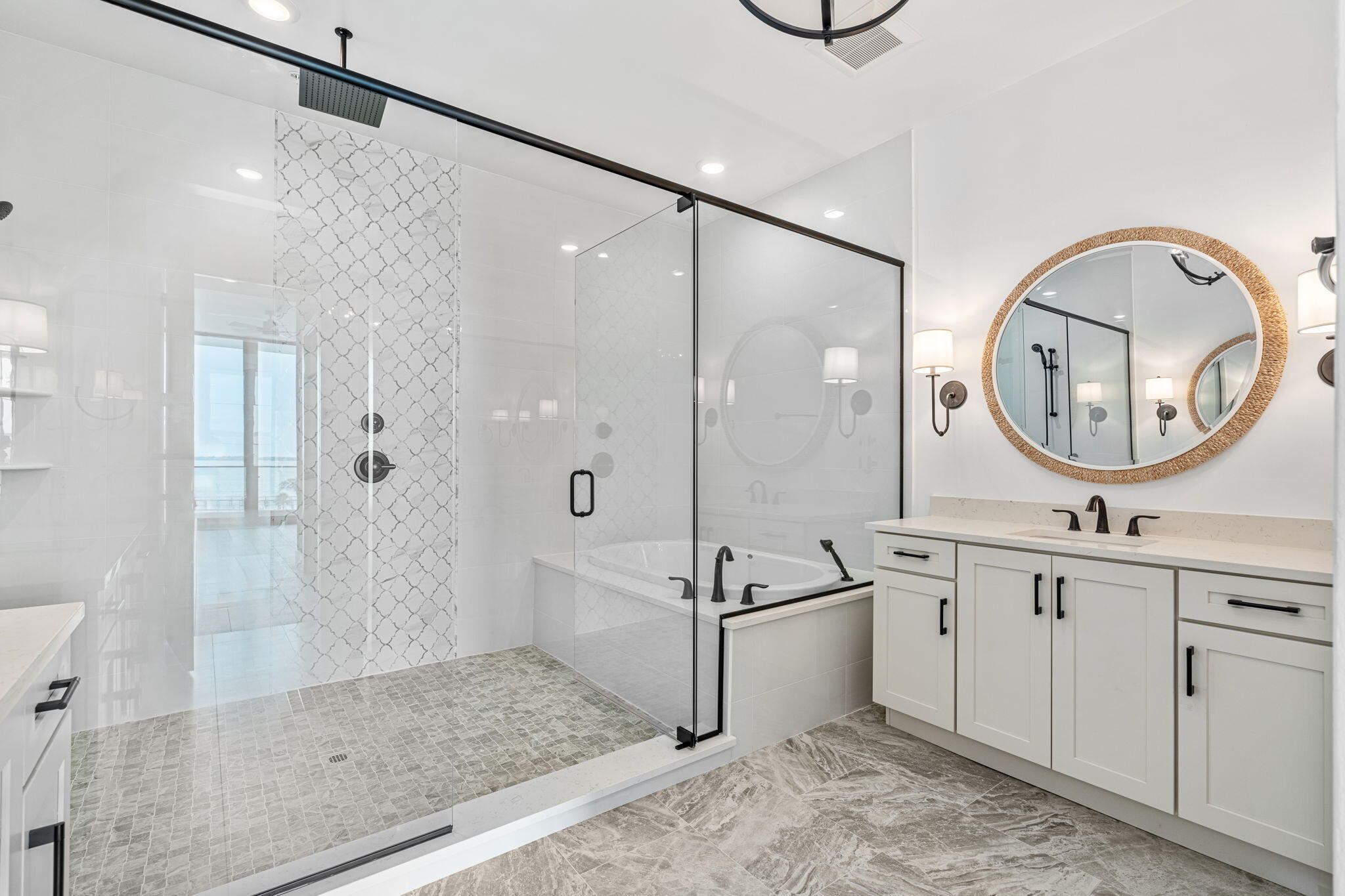 225 Strand Drive, Unit 404 Melbourne Beach, FL 32951 - Photo 14 of 30 a bathroom with a tub a sink and a mirror