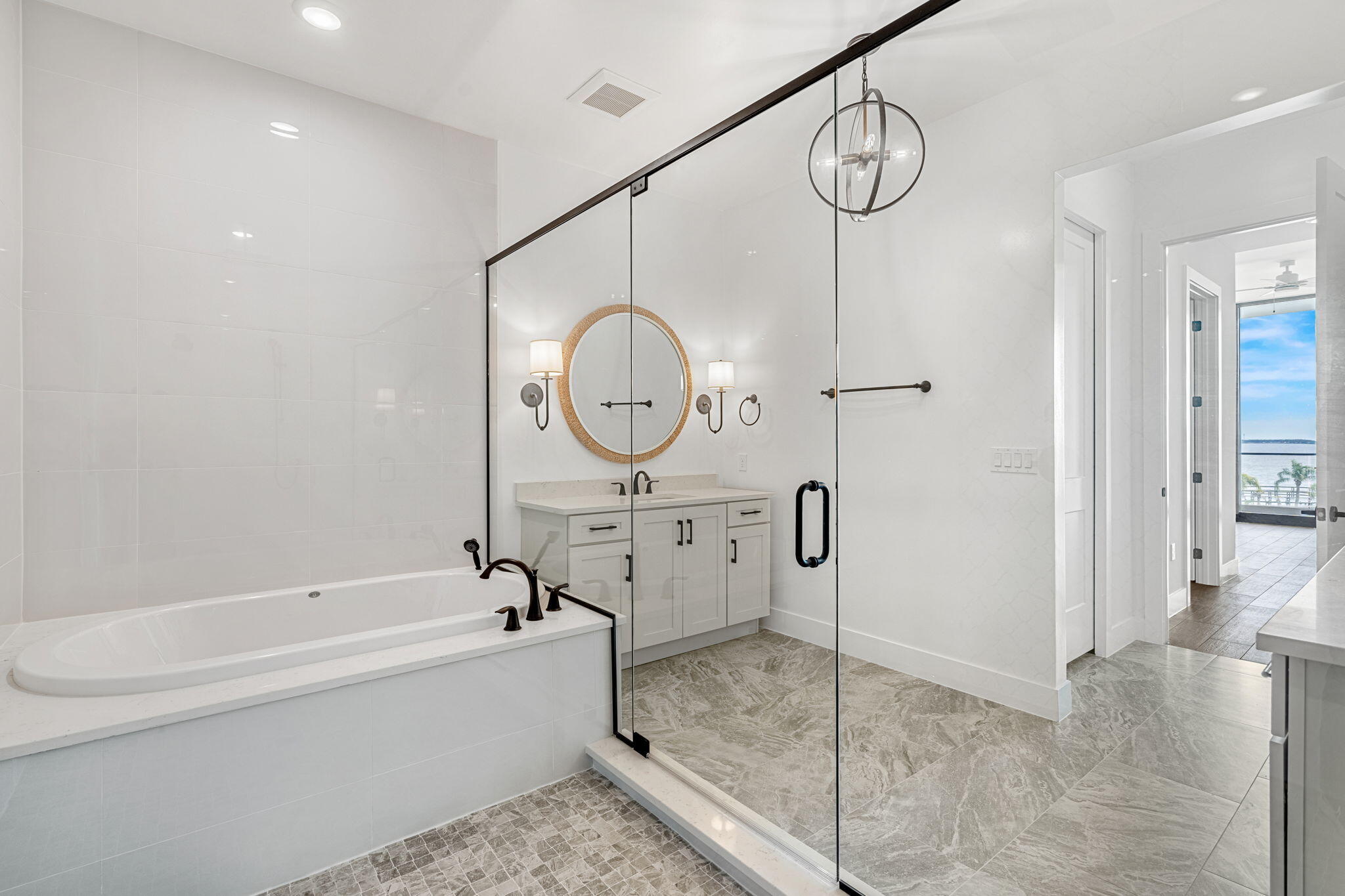 225 Strand Drive, Unit 404 Melbourne Beach, FL 32951 - Photo 16 of 30 a spacious bathroom with a granite countertop sink mirror vanity and bathtub