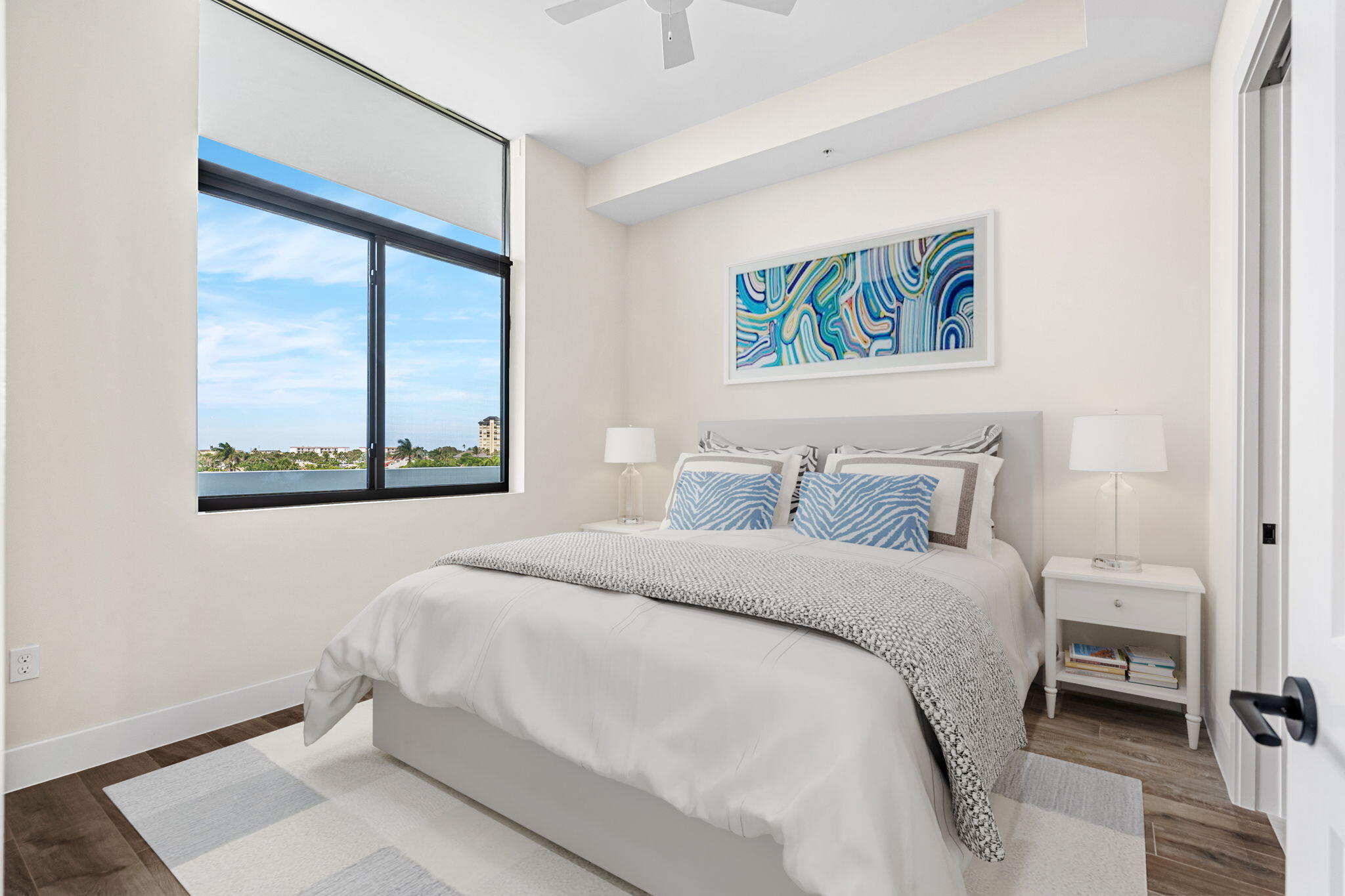 225 Strand Drive, Unit 404 Melbourne Beach, FL 32951 - Photo 17 of 30 a bedroom with a bed and a painting on the wall