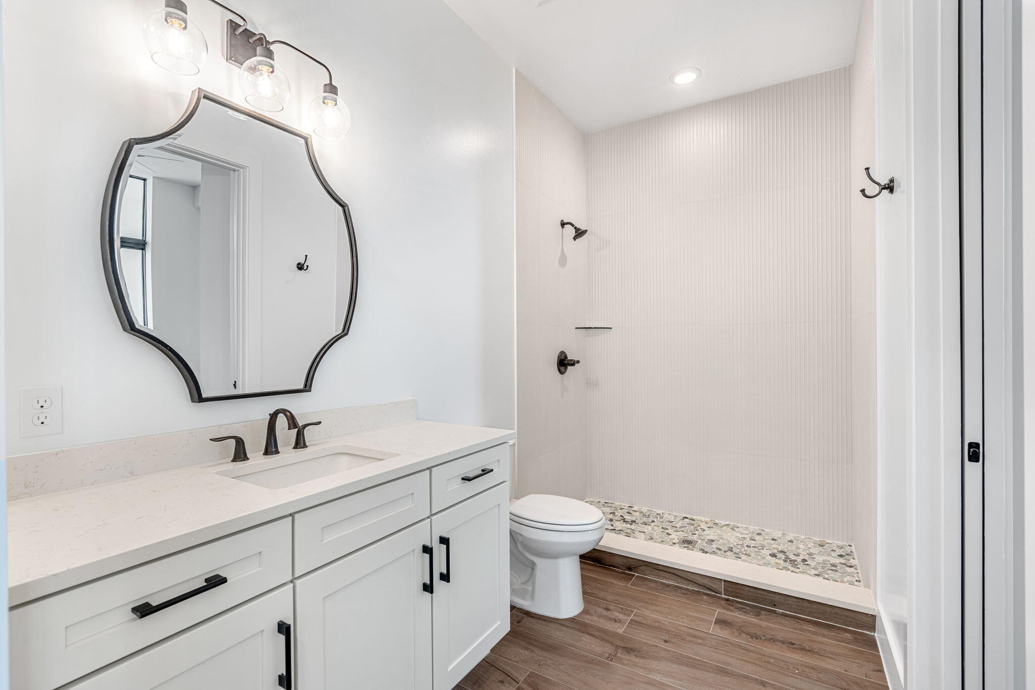 225 Strand Drive, Unit 404 Melbourne Beach, FL 32951 - Photo 20 of 30 a bathroom with a sink a toilet and a mirror
