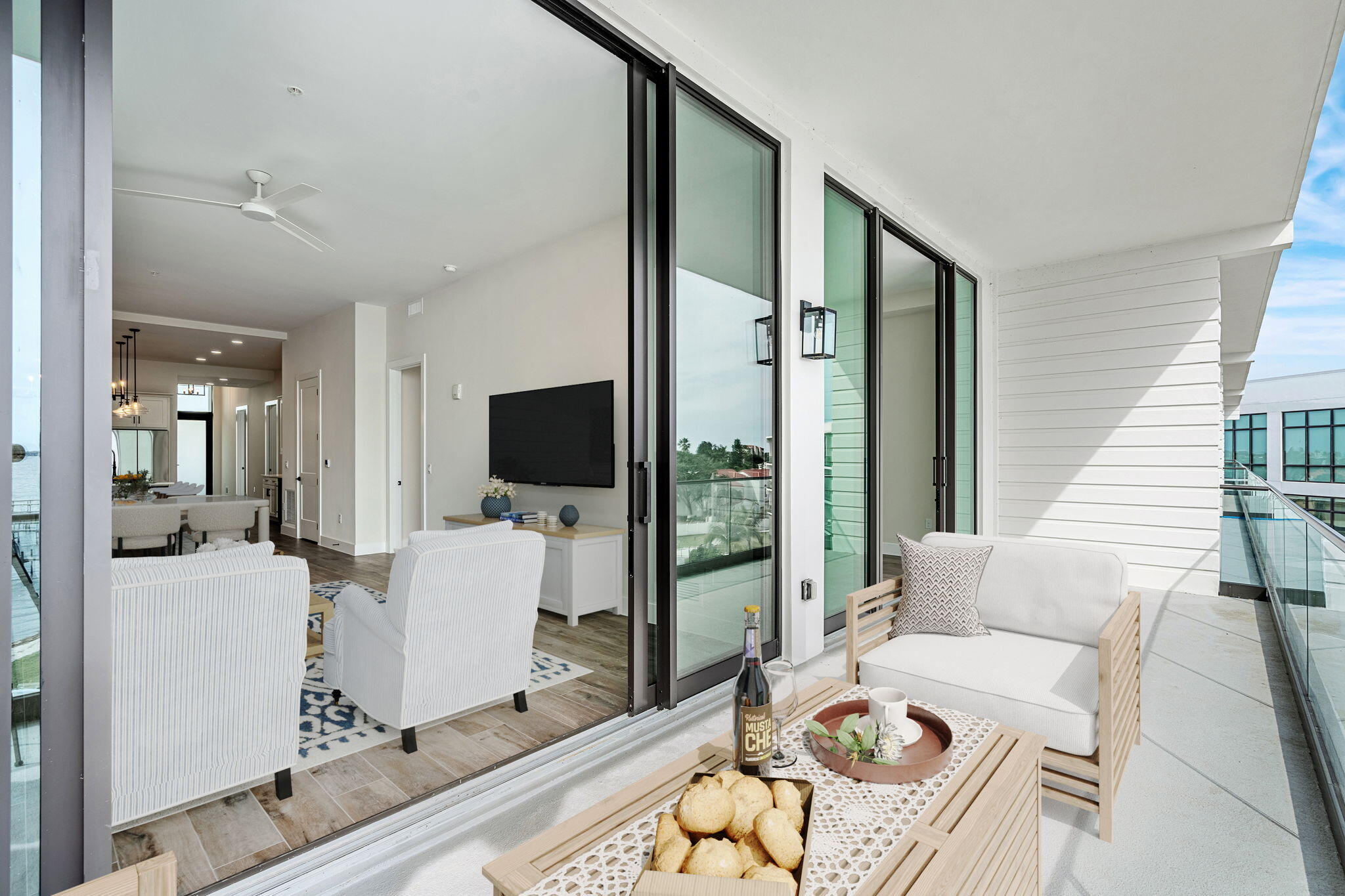 225 Strand Drive, Unit 404 Melbourne Beach, FL 32951 - Photo 5 of 30 a living room with furniture a flat screen tv and a large window