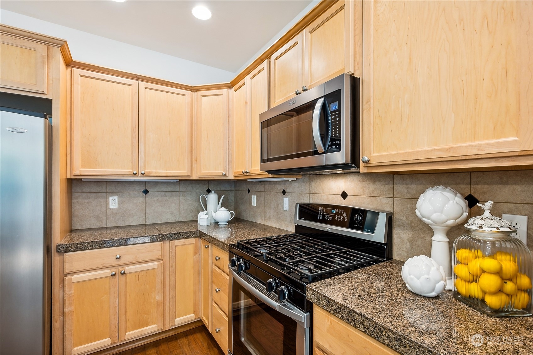 3426 172nd Place Southeast Bothell, WA 98012 - Photo 12 of 33 a kitchen with stainless steel appliances granite countertop a stove a microwave and cabinets