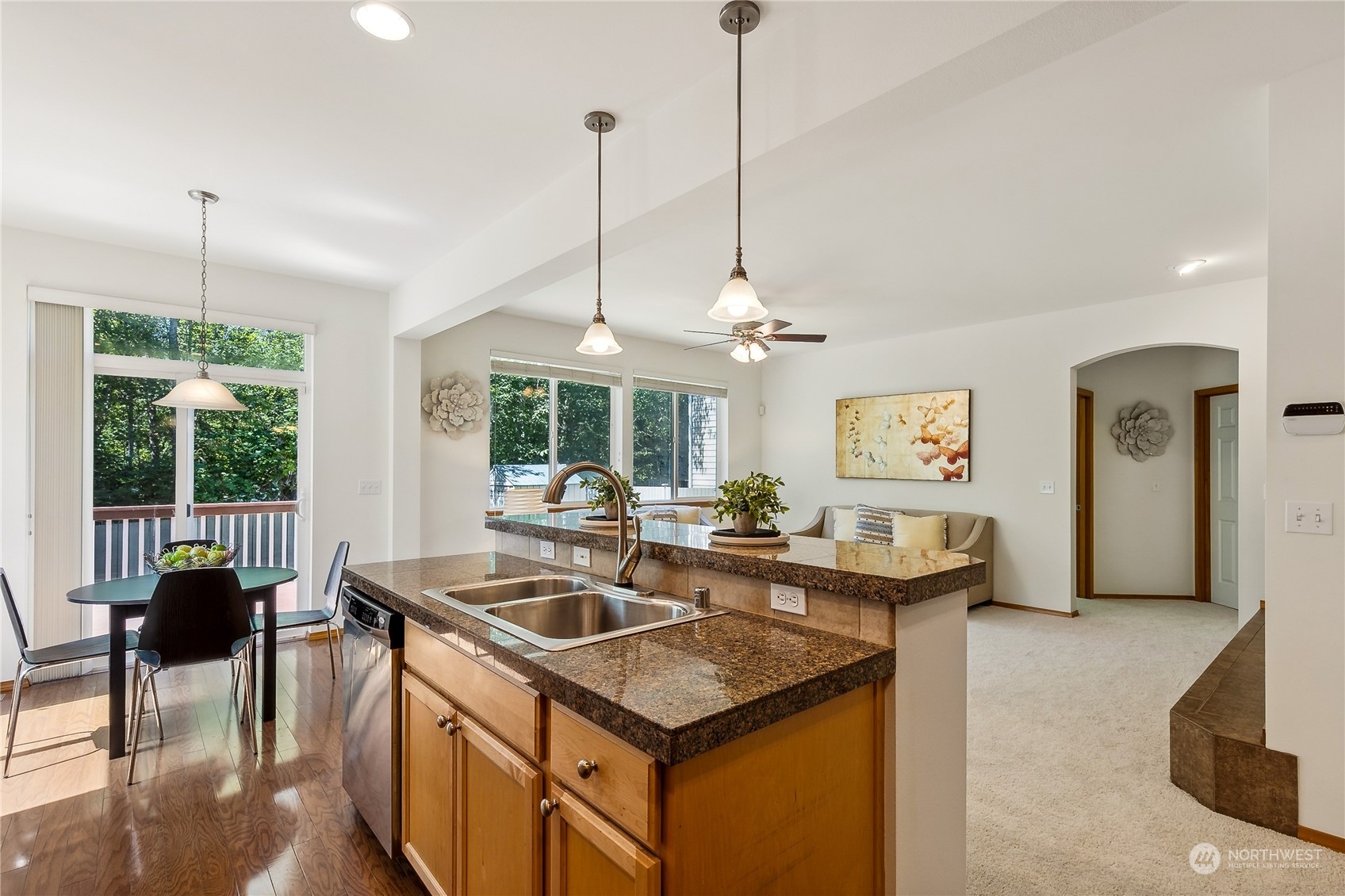 3426 172nd Place Southeast Bothell, WA 98012 - Photo 13 of 33 a kitchen with stainless steel appliances granite countertop a sink a stove and a wooden floor