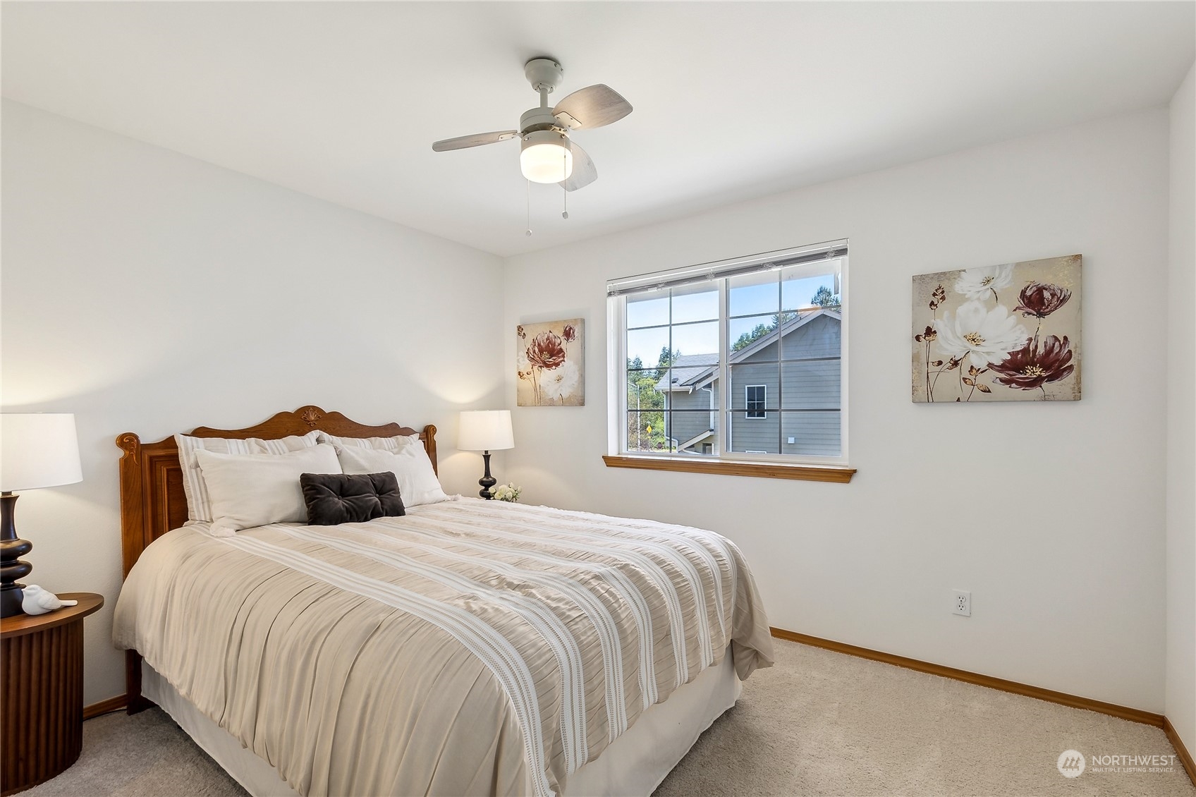 3426 172nd Place Southeast Bothell, WA 98012 - Photo 17 of 33 a bedroom with a large bed and a chandelier