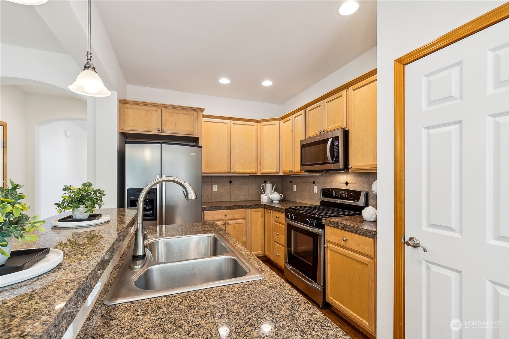 3426 172nd Place Southeast Bothell, WA 98012 - Photo 10 of 33 a kitchen with granite countertop a sink and a stove top oven