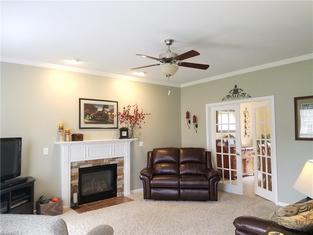 7822 Wilson Farm Road Summerfield, NC 27358 - Photo 16 of 30 Living room with french doors leading into Dining area. Gas logs and recess lighting. Updated fans, lighting and fixtures throughout