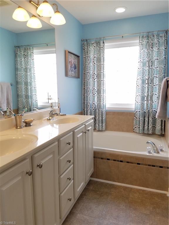 7822 Wilson Farm Road Summerfield, NC 27358 - Photo 20 of 30 Master bathroom with double vanities and garden tub.