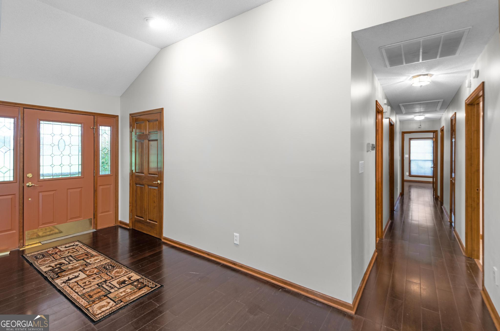 4909 Perry Road Claxton, GA 30417 - Photo 19 of 54 a view of hallway with livingroom and wooden floor