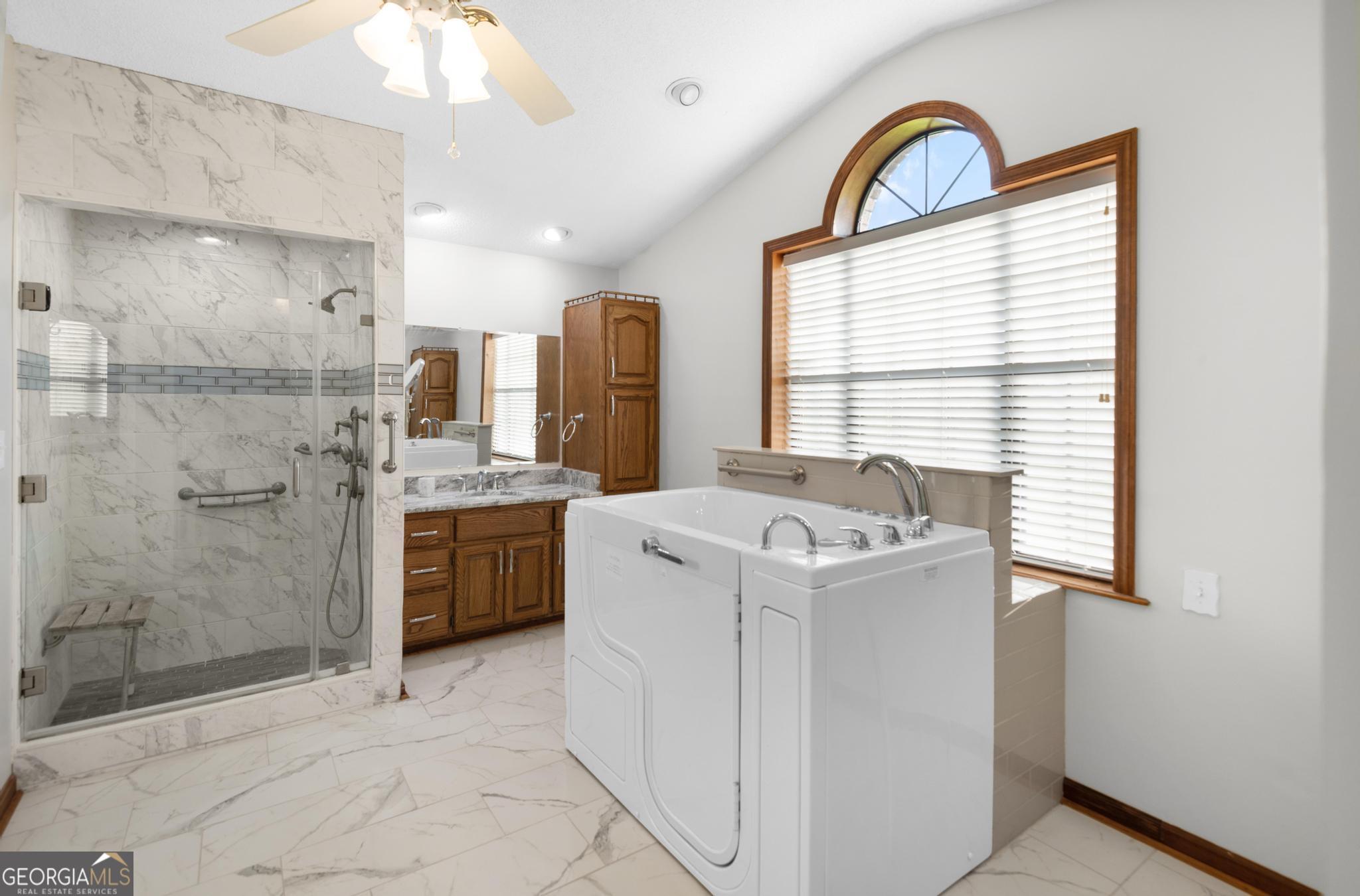 4909 Perry Road Claxton, GA 30417 - Photo 35 of 54 a view of washer and dryer with a kitchen
